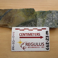 AK-20-044@ 662.23m : Red garnet-magnetite skarn in contact with retrograde altered porphyry intrusion